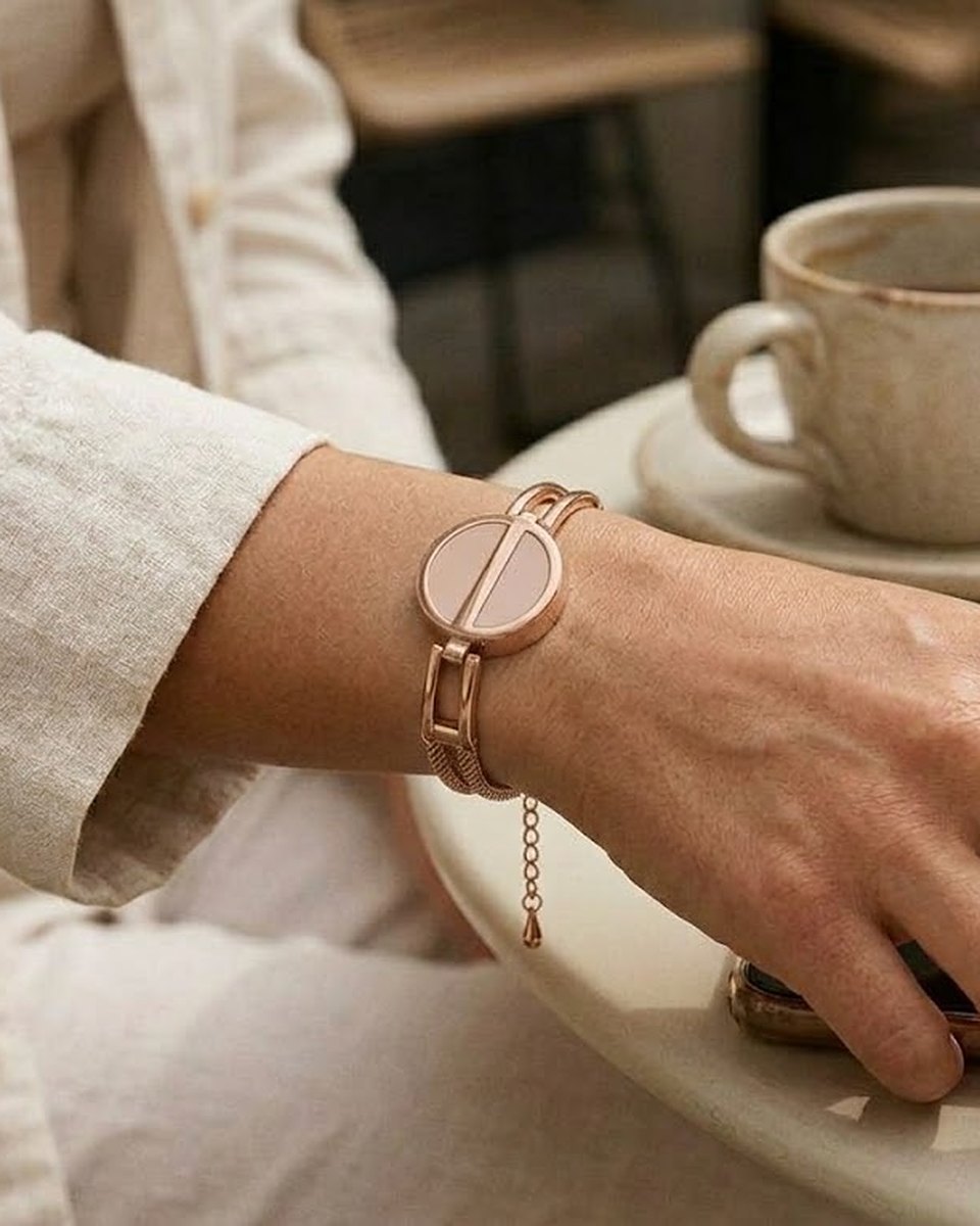The Flex worn on the wrist: a solid metal bangle with the Charm framed in metal